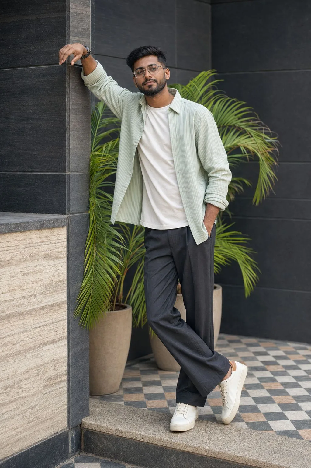 Stylish Indian Man Leaning Against Modern Wall