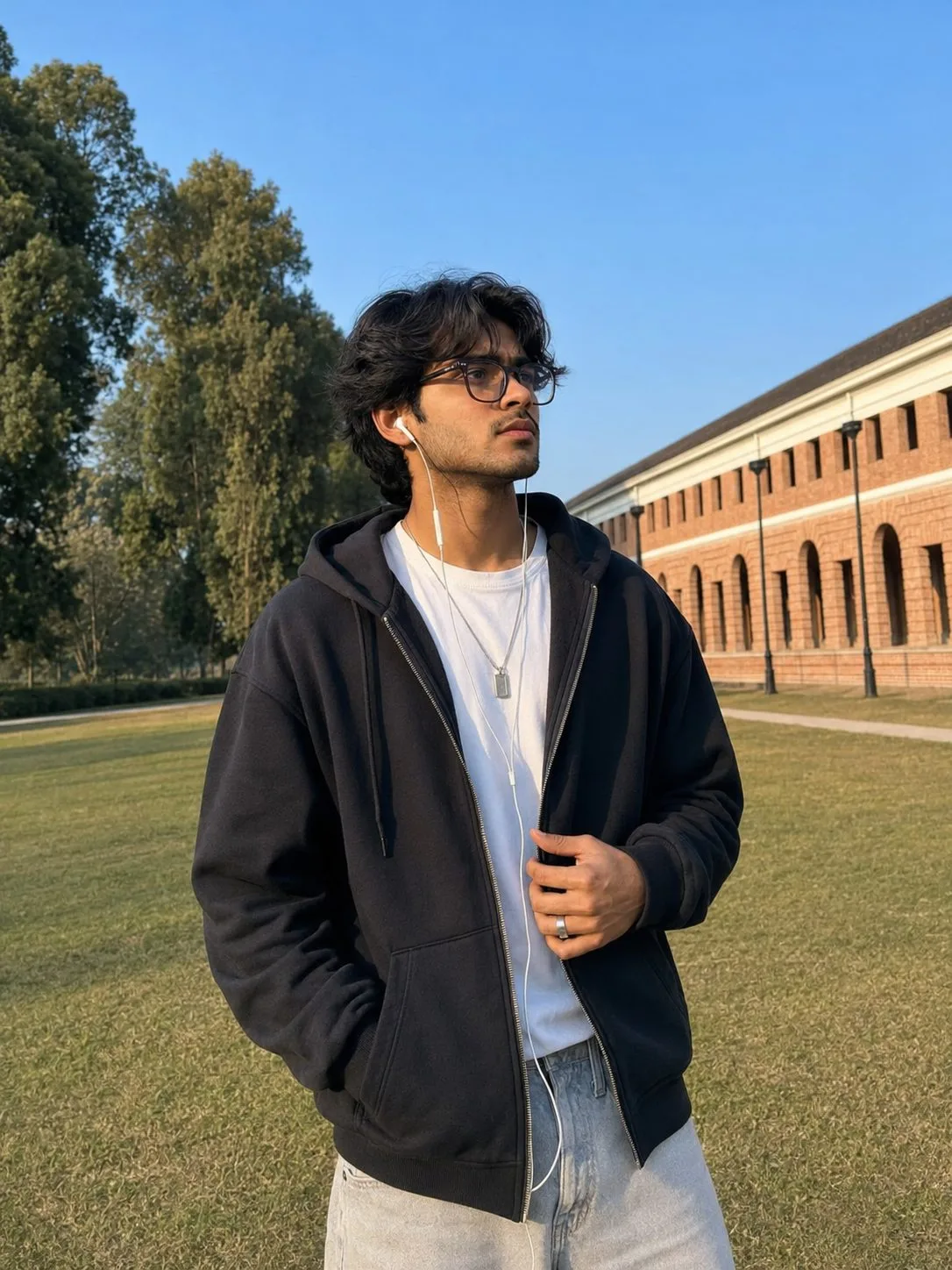 Indian Man Wearing a Black Hoodie at a Heritage Campus